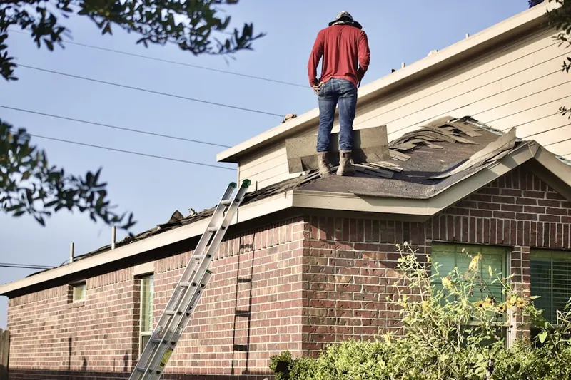 Professional roofer working on a residential roof in Melrose Park